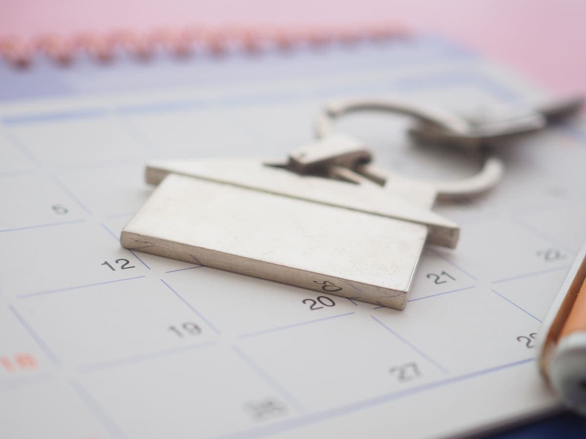 A calendar and house keys on a desk