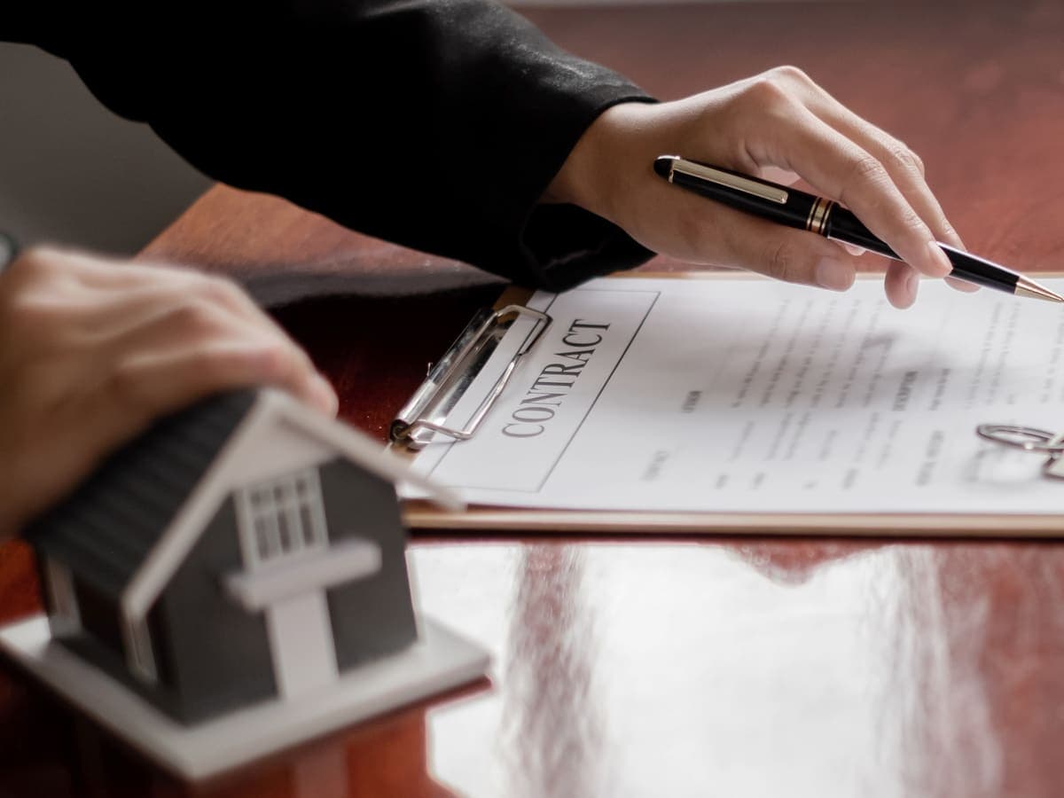 Several offer documents and a pen on a desk